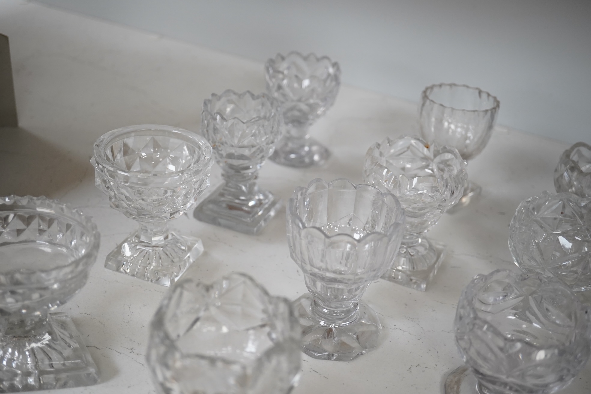 A group of twelve Georgian cut glass salts, tallest 9cm. Condition - fair to good, some chipping